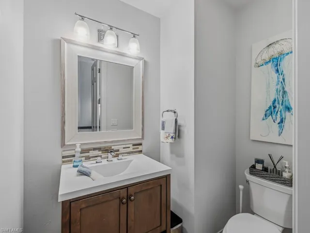 a bathroom with a sink toilet and a mirror