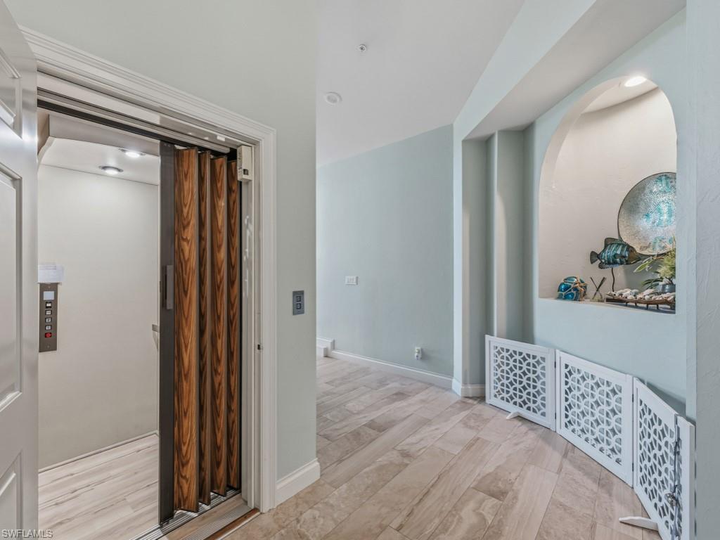 175 Colonade Circle Naples, FL 34103 - Photo 7 of 45 a bedroom with a bed and a painting on the wall