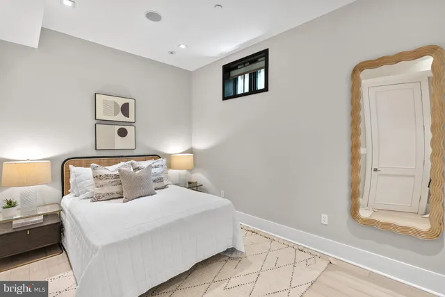 a bedroom with a bed and a painting on the wall