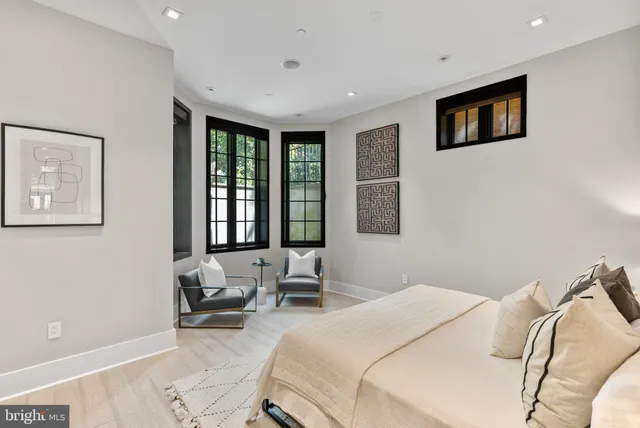 a bedroom with a bed and glass windows