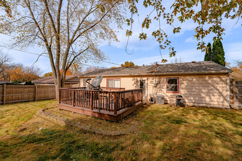 213 Rockhurst Road Bolingbrook, IL 60440 - Photo 12 of 14 a view of a house with wooden fence and a tree