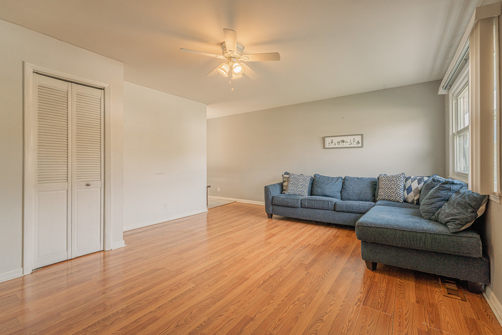 213 Rockhurst Road Bolingbrook, IL 60440 - Photo 4 of 14 a living room with couches and potted plant with wooden floor