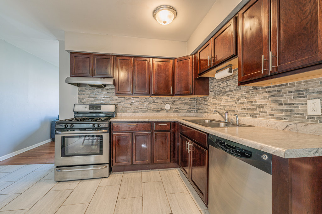 213 Rockhurst Road Bolingbrook, IL 60440 - Photo 6 of 14 a kitchen with stainless steel appliances granite countertop a stove sink and cabinets