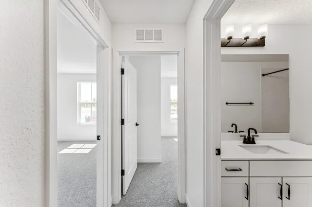 a bathroom with a sink vanity and mirror