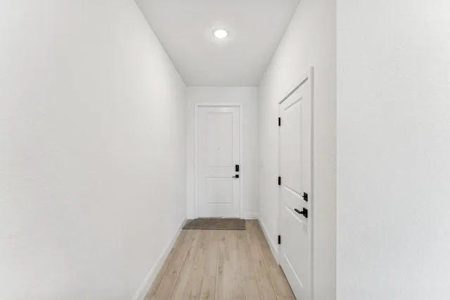 a view of a room with wooden floor