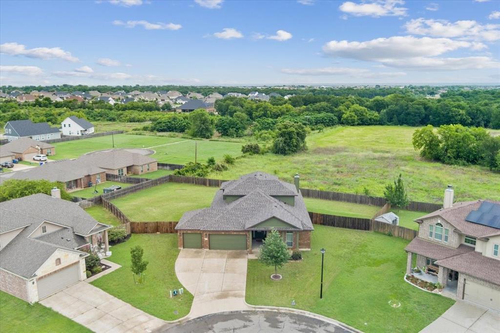an aerial view of a house with garden space and ocean view