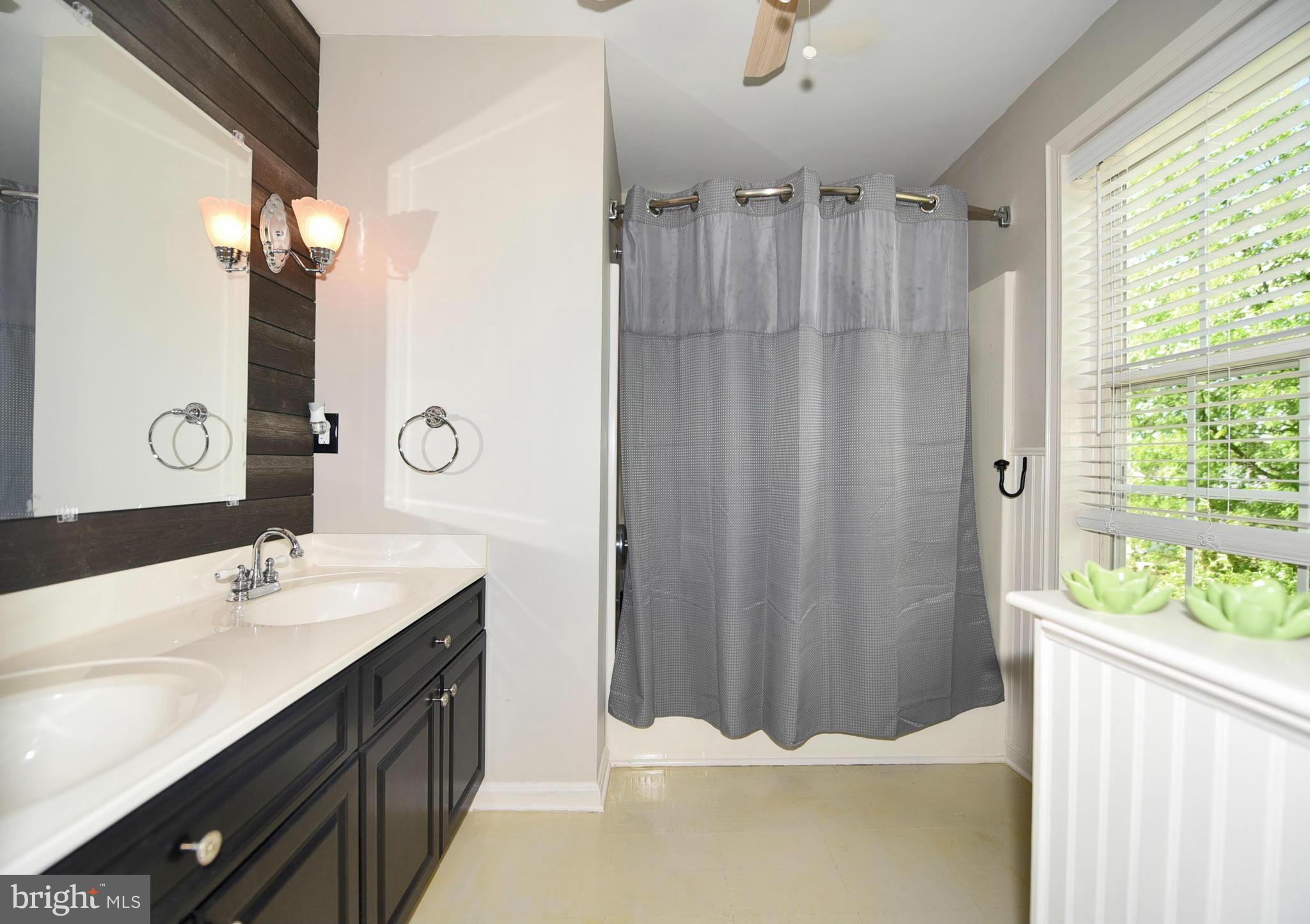 4505 King George Court Nottingham, MD 21236 - Photo 17 of 30 a bathroom with a double vanity sink and a mirror