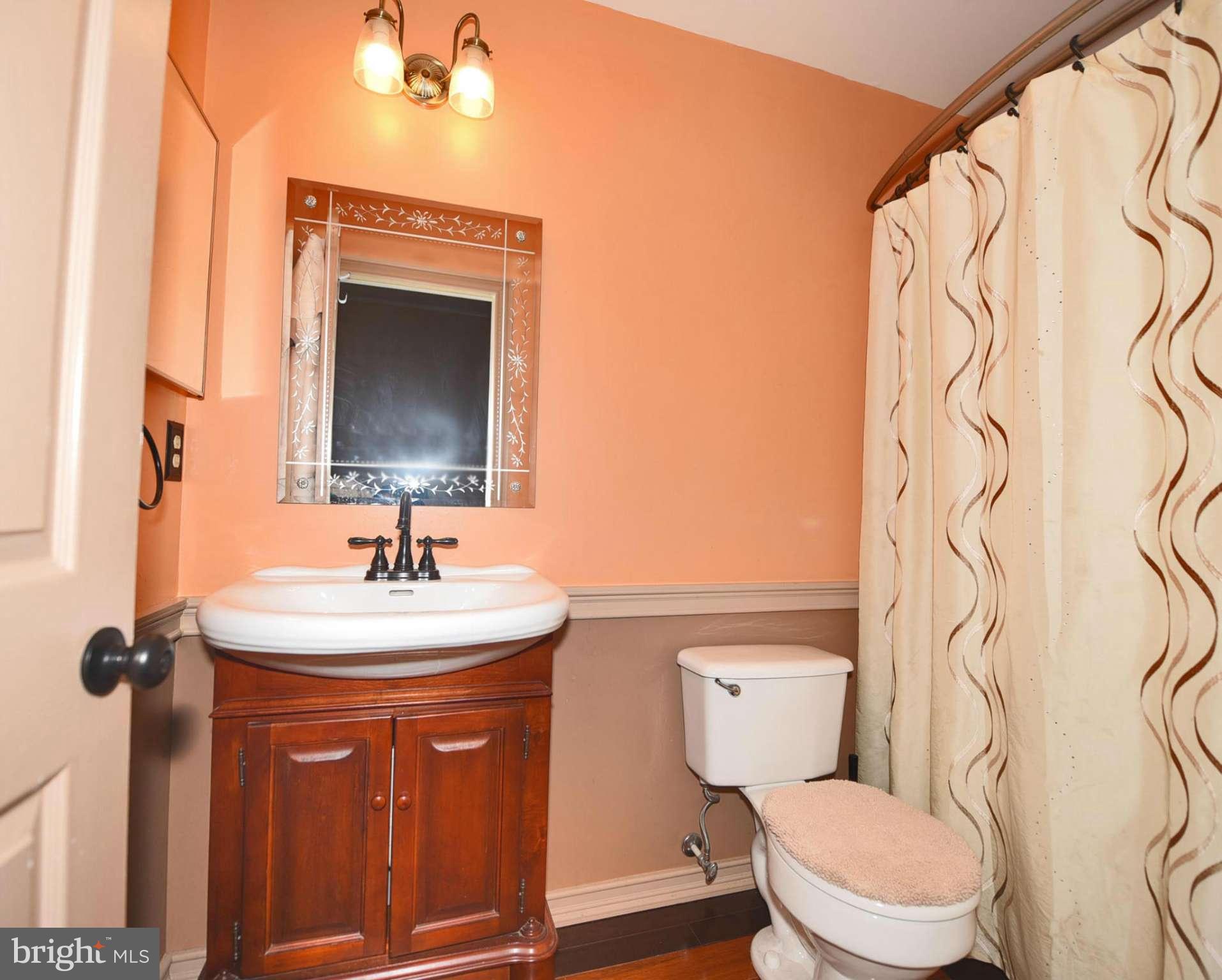 4505 King George Court Nottingham, MD 21236 - Photo 21 of 30 a bathroom with a toilet sink and mirror