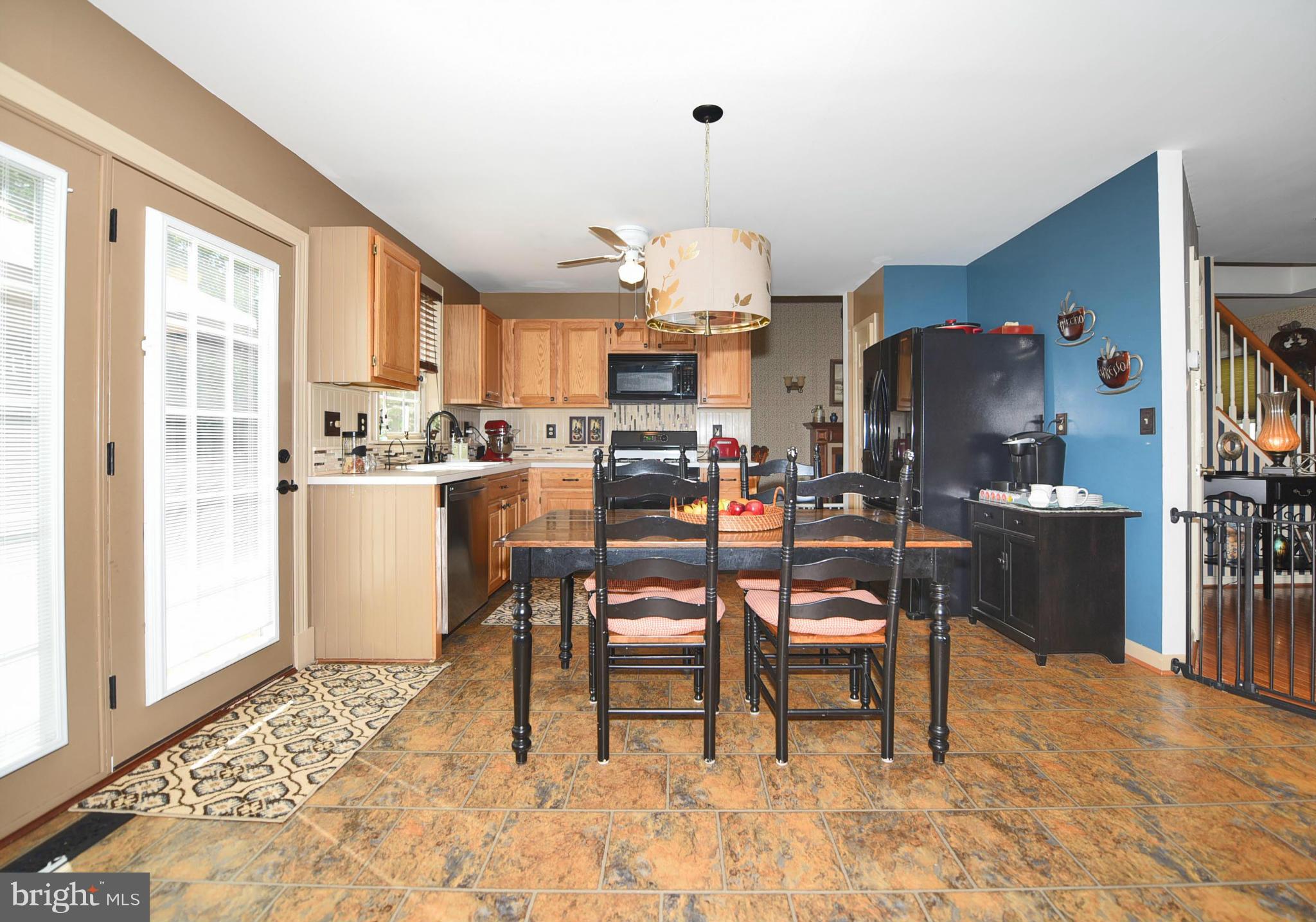 4505 King George Court Nottingham, MD 21236 - Photo 9 of 30 a living room with couches a dining table and chairs with wooden floor