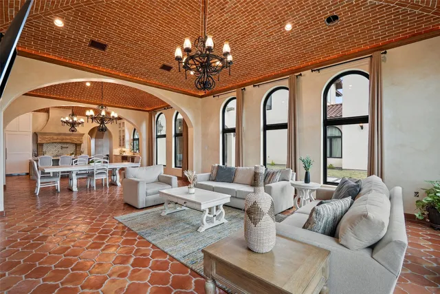 a view of a dining room with furniture and chandelier