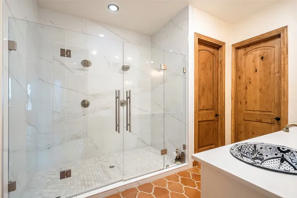 a view of a living room and hall with a large window