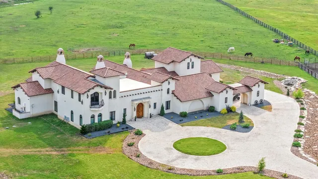 an aerial view of residential houses with outdoor space and swimming pool