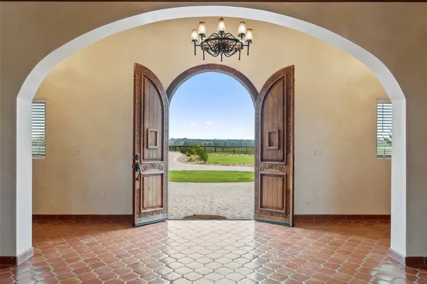 a large living room with a large pool table and chairs