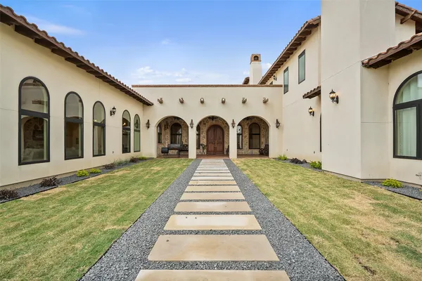 a view of a hallway with mirror and window