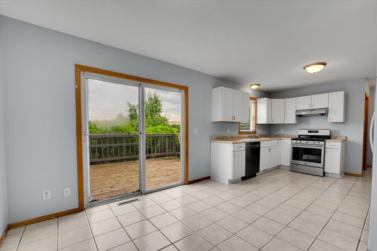 6621 Samantha Lane Rockford, IL 61107 - Photo 13 of 38 a kitchen with a stove a sink and a refrigerator