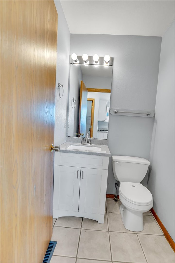 6621 Samantha Lane Rockford, IL 61107 - Photo 16 of 38 a bathroom with a toilet sink and mirror