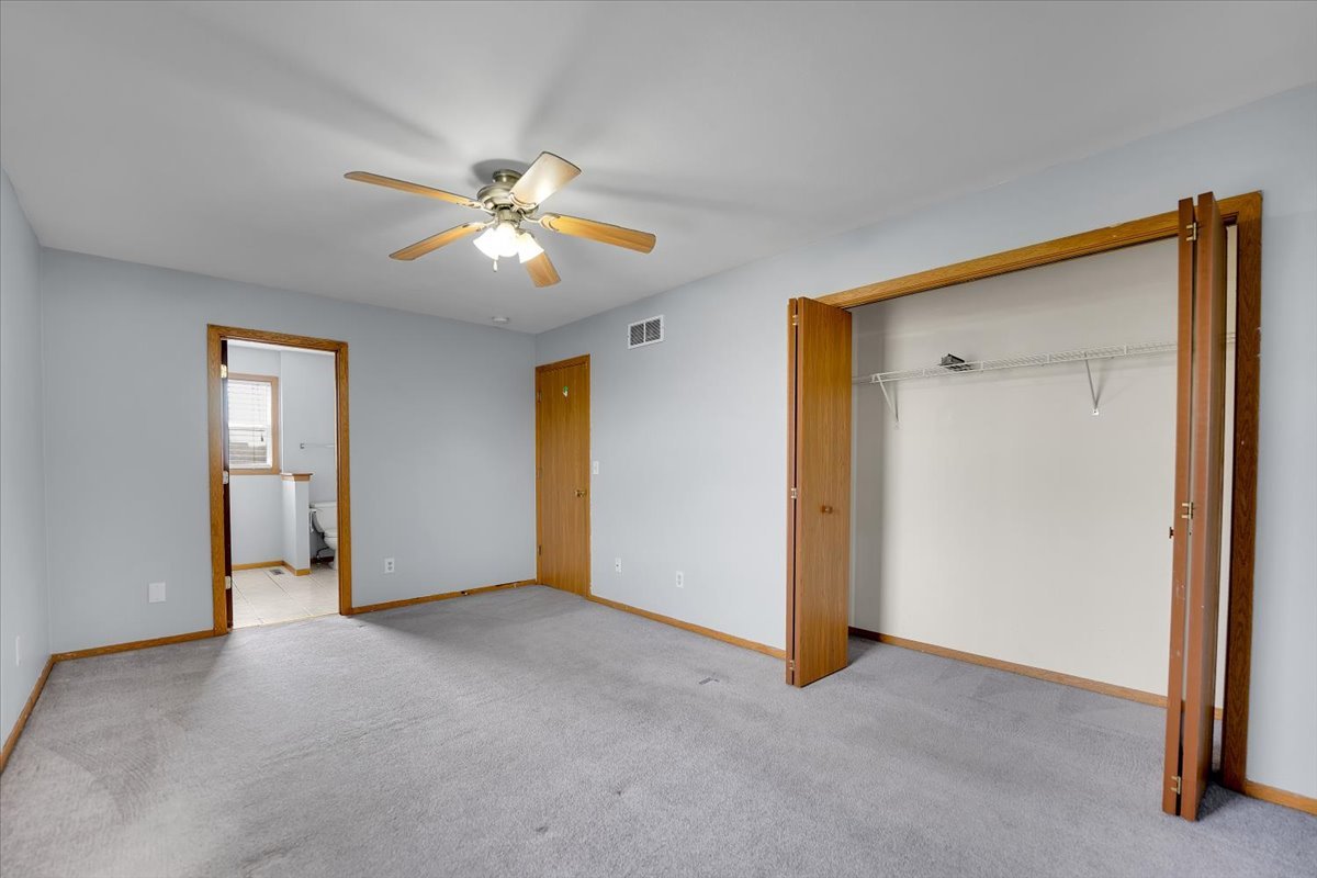 6621 Samantha Lane Rockford, IL 61107 - Photo 19 of 38 a view of an empty room with a ceiling fan