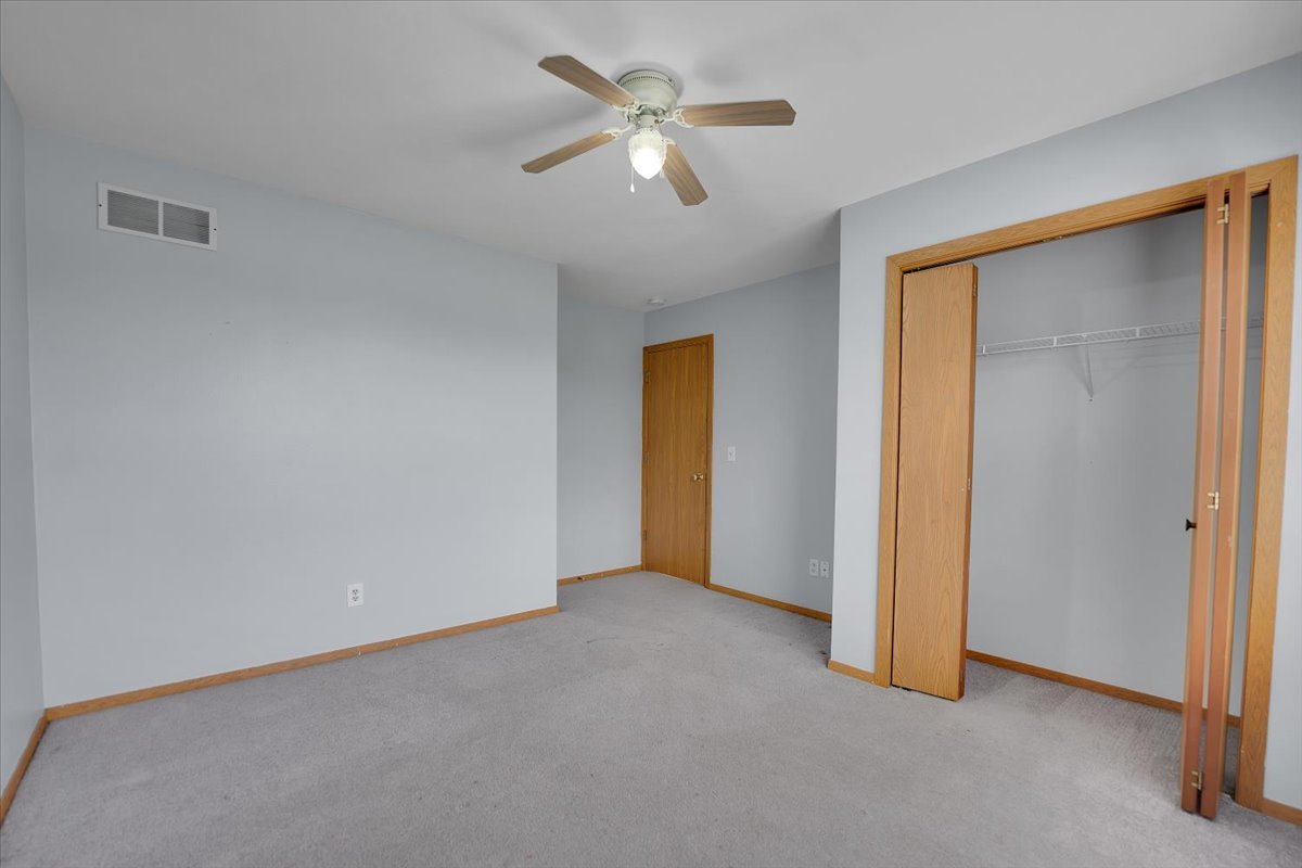 6621 Samantha Lane Rockford, IL 61107 - Photo 24 of 38 a view of an empty room with a ceiling fan