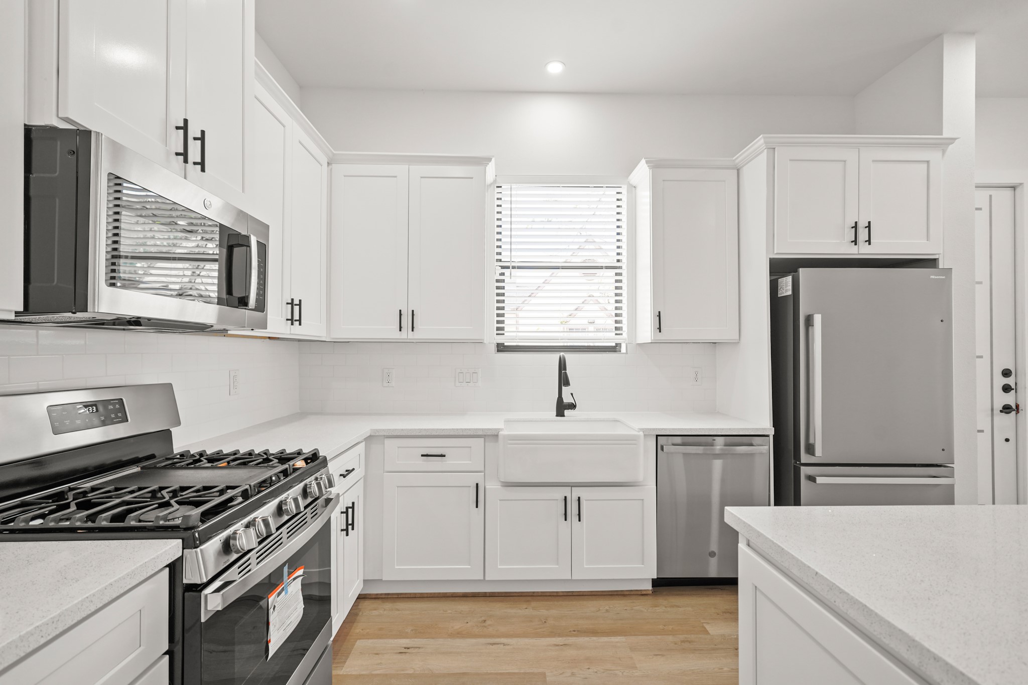 a kitchen with a stove a sink and a refrigerator