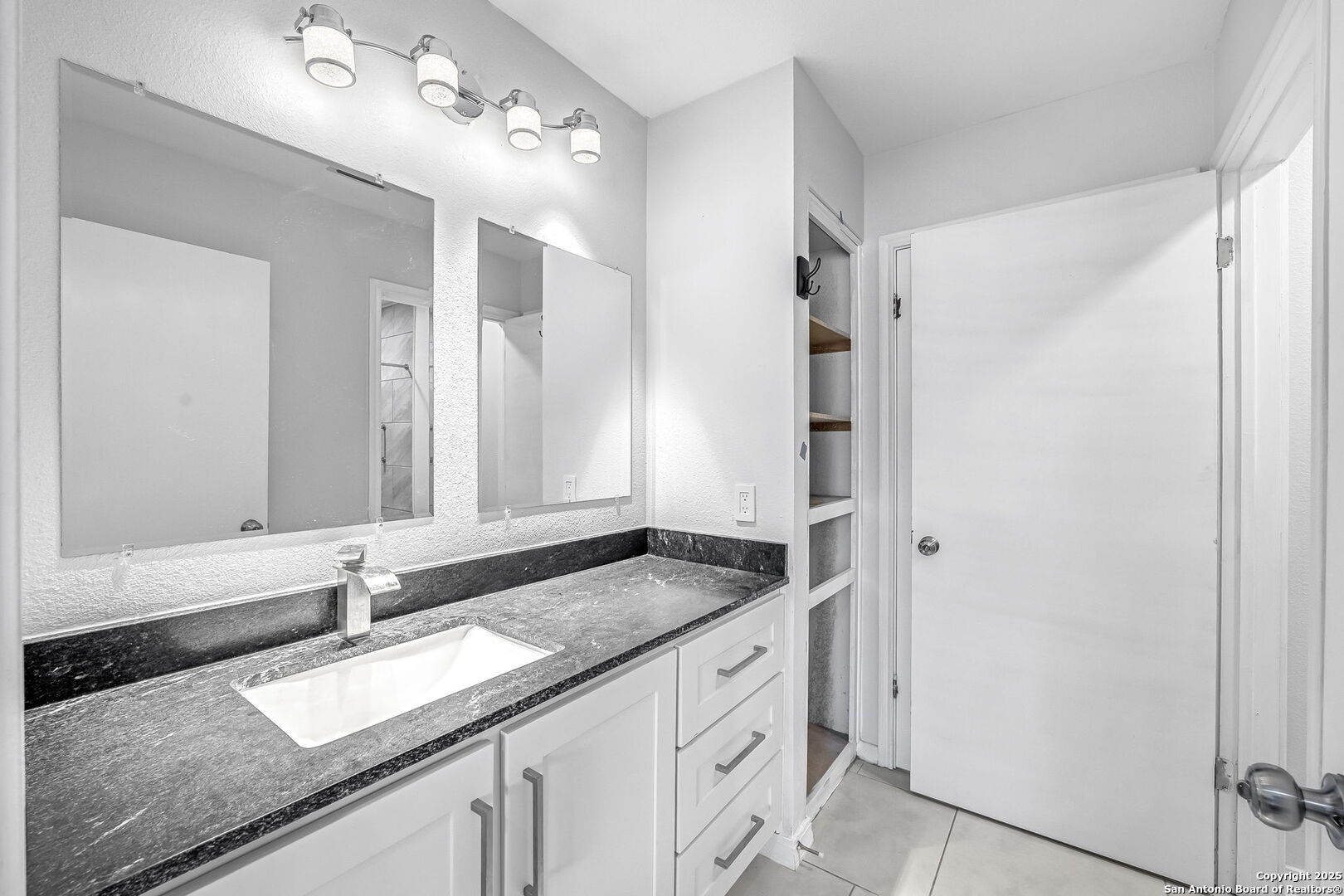514 Jackson Keller Road San Antonio, TX 78216 - Photo 14 of 25 a bathroom with a granite countertop sink and a mirror