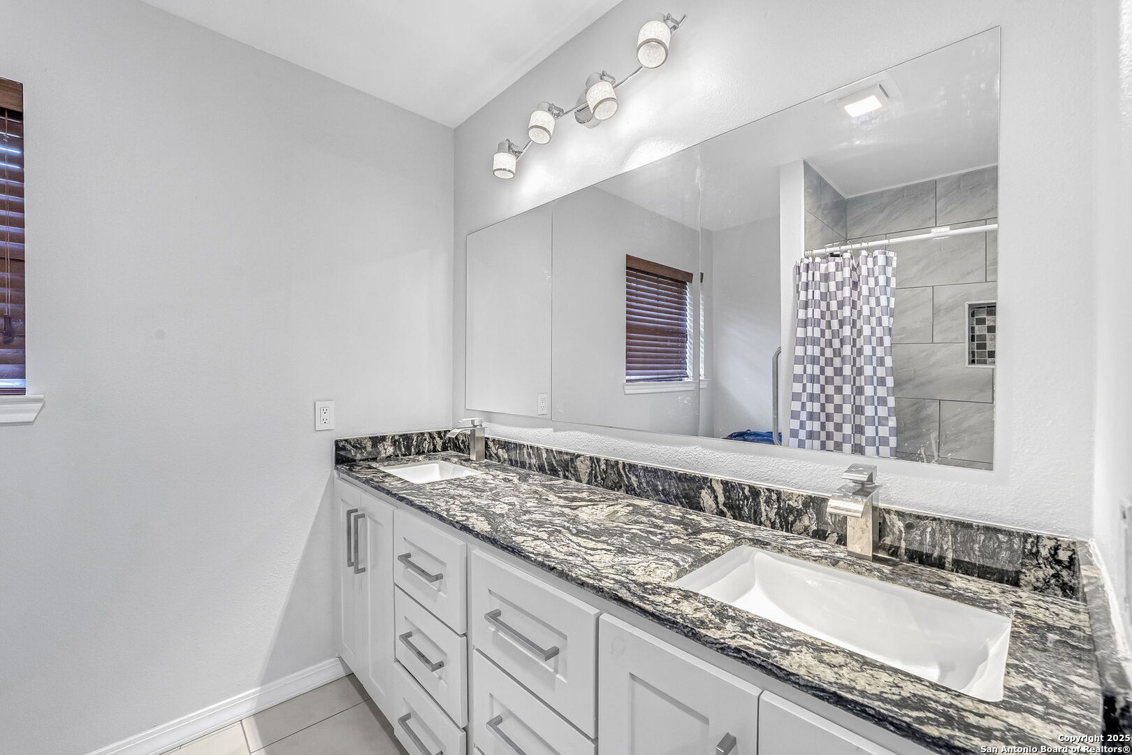 514 Jackson Keller Road San Antonio, TX 78216 - Photo 19 of 25 a bathroom with a granite countertop sink and a mirror