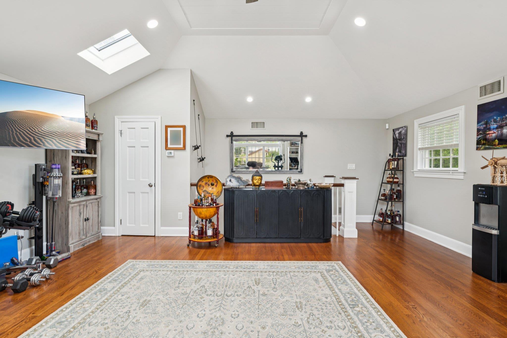 21 Inlet View Path East Moriches, NY 11940 - Photo 15 of 40 Living room featuring a skylight, wood finished floors, recessed lighting, and vaulted ceiling