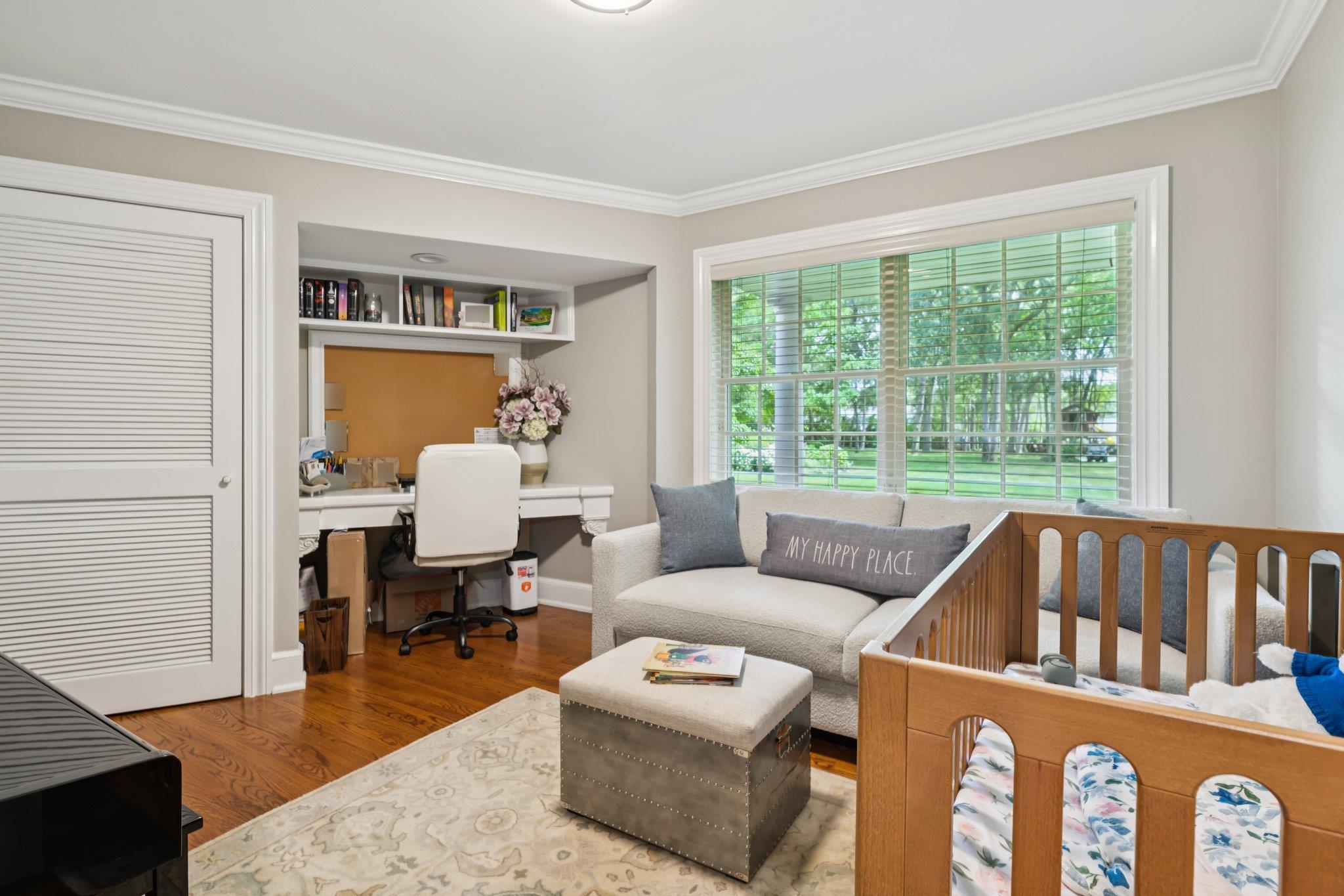 21 Inlet View Path East Moriches, NY 11940 - Photo 19 of 40 Bedroom featuring an office area, crown molding, wood finished floors, and a crib