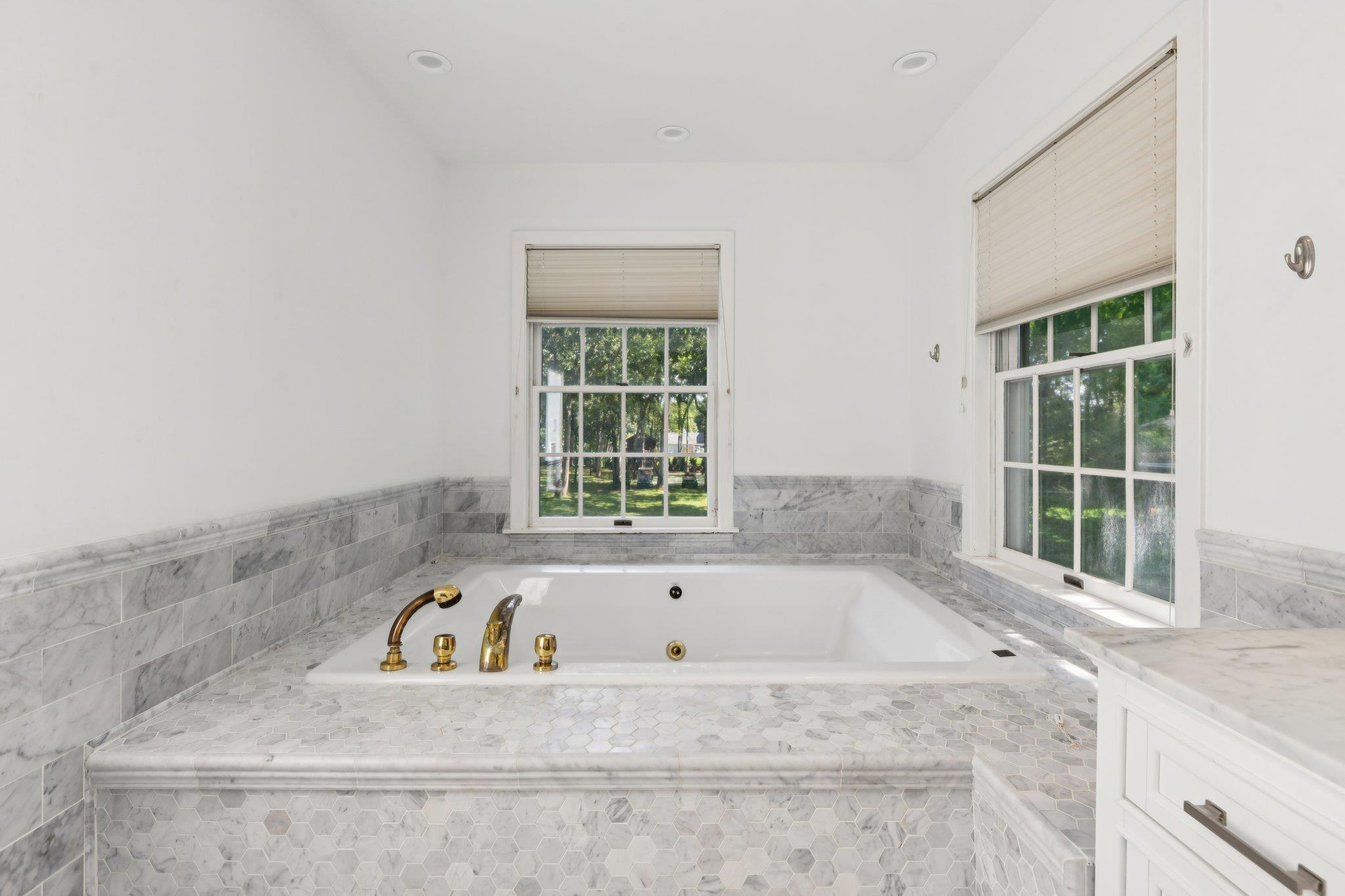 21 Inlet View Path East Moriches, NY 11940 - Photo 23 of 40 Full bathroom with healthy amount of natural light, a tub with jets, vanity, and recessed lighting