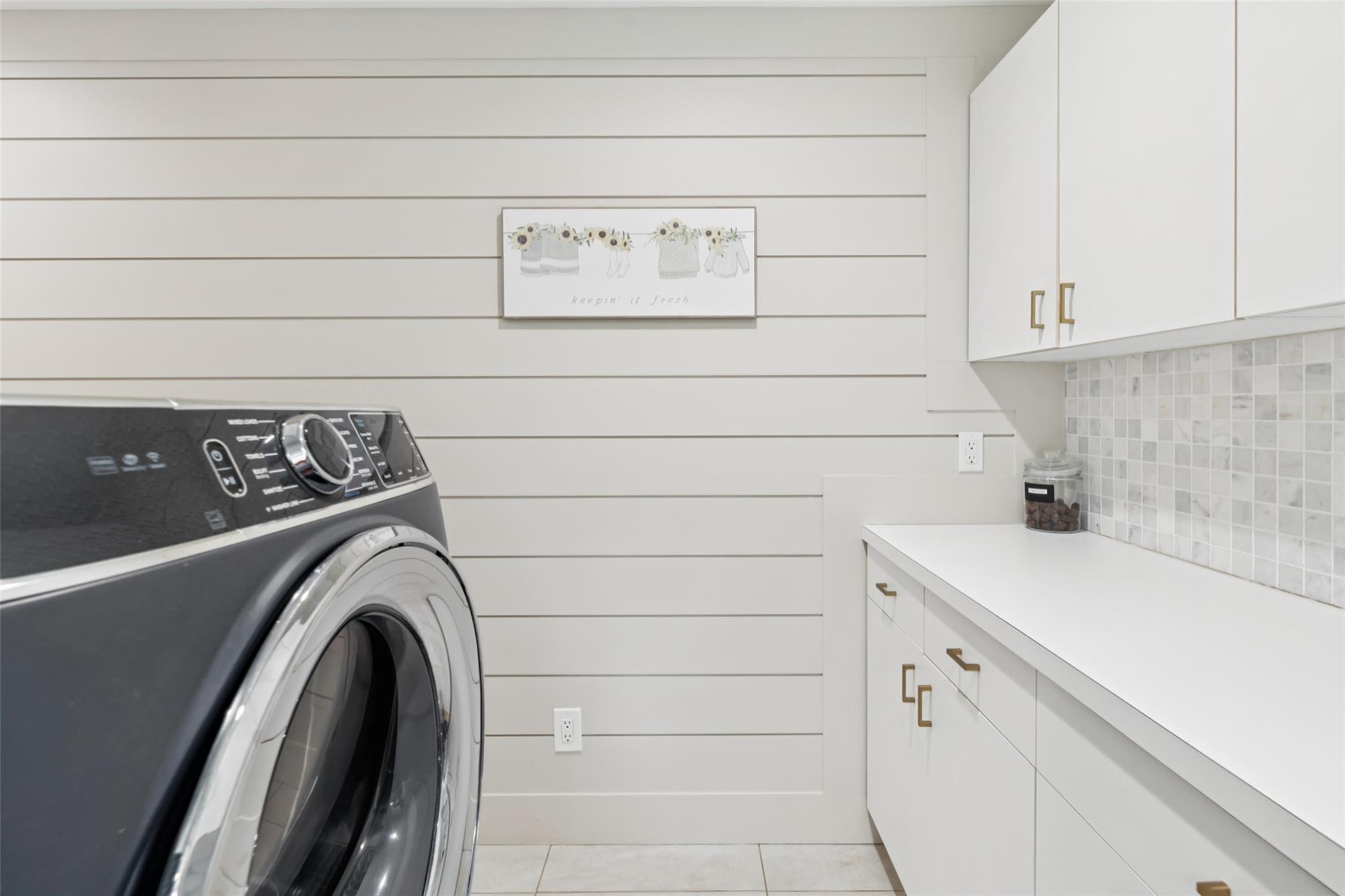 21 Inlet View Path East Moriches, NY 11940 - Photo 26 of 40 Laundry area featuring cabinet space, washer / dryer, and light tile patterned floors