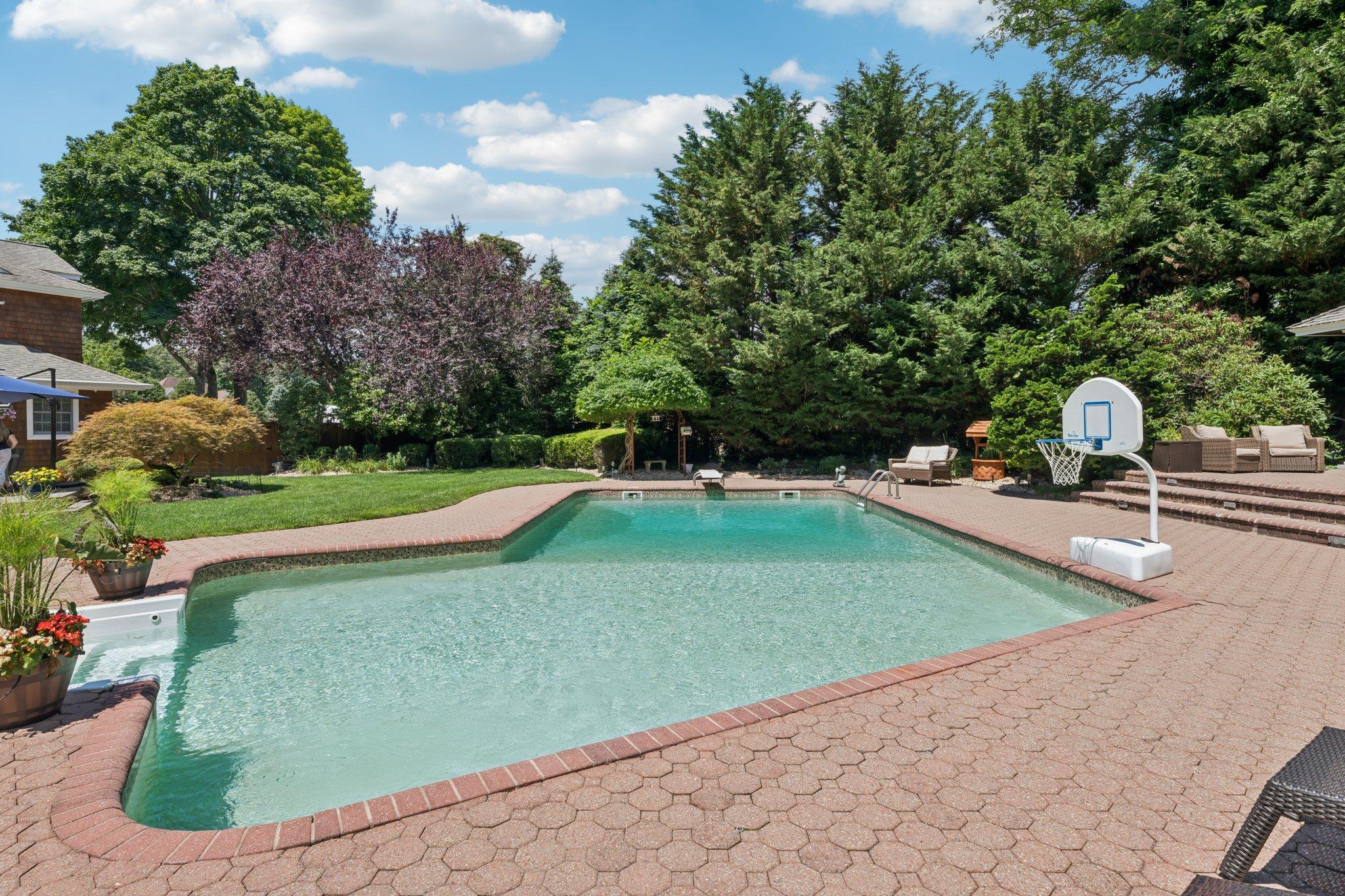 21 Inlet View Path East Moriches, NY 11940 - Photo 32 of 40 Swimming pool with a patio area, a lawn, and view of wooded area