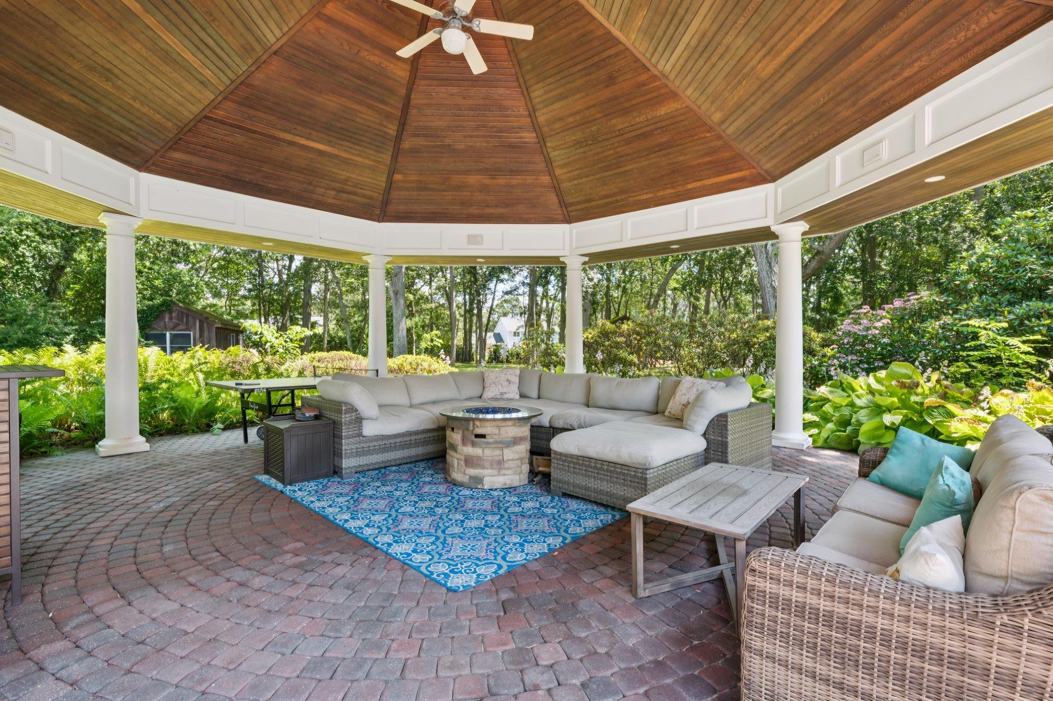 21 Inlet View Path East Moriches, NY 11940 - Photo 33 of 40 View of patio with an outdoor living space with a fire pit, a ceiling fan, a gazebo, and view of wooded area