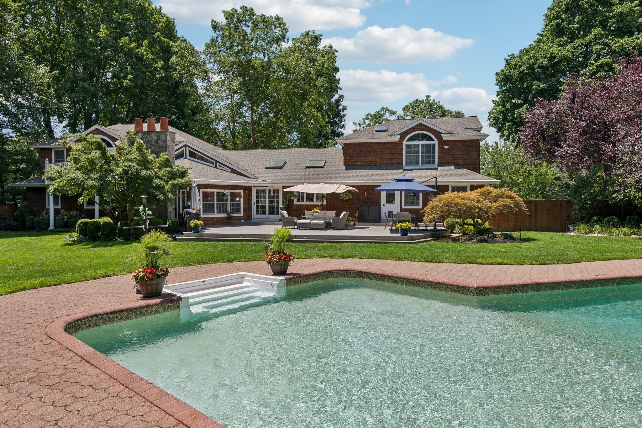 21 Inlet View Path East Moriches, NY 11940 - Photo 37 of 40 Rear view of house with an outdoor pool, an outdoor hangout area, and a patio