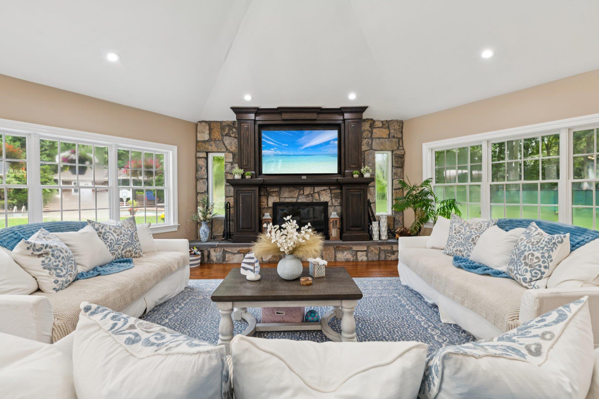 21 Inlet View Path East Moriches, NY 11940 - Photo 5 of 40 Living room with wood finished floors, plenty of natural light, lofted ceiling, recessed lighting, and a fireplace