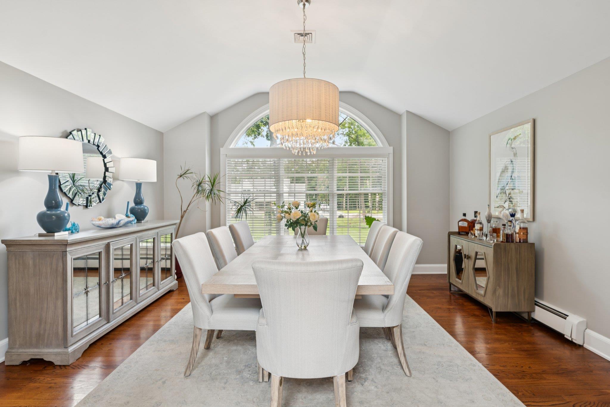 21 Inlet View Path East Moriches, NY 11940 - Photo 7 of 40 Dining area with a chandelier, vaulted ceiling, a baseboard radiator, and wood finished floors