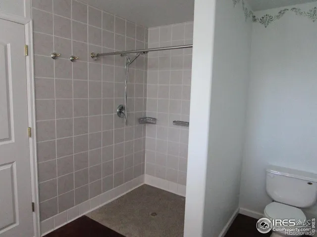 a bathroom with a toilet and a shower