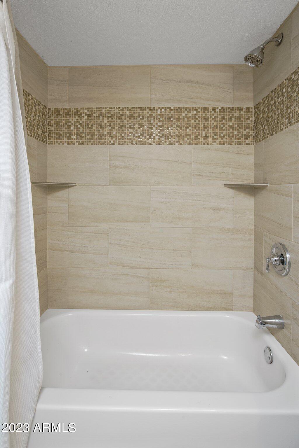 6609 East Phelps Road Scottsdale, AZ 85254 - Photo 23 of 83 a bathroom with a bathtub and shower