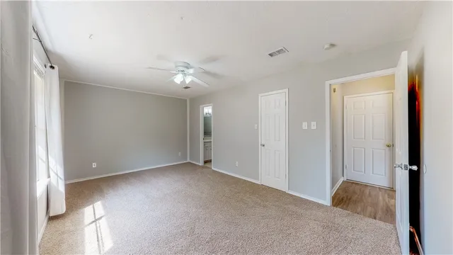 a view of a big room with closet and chandelier fan