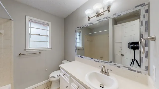 a bathroom with a sink toilet and shower