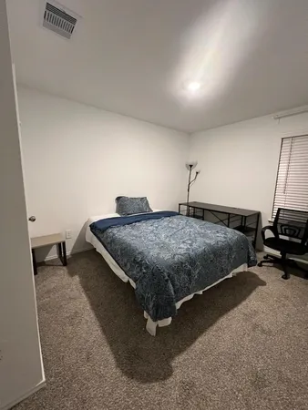 an empty room with wooden floor and closet