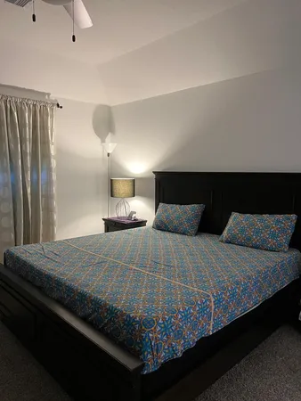 a bedroom with a bed and a night stand