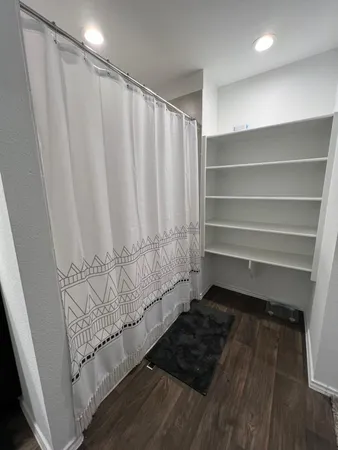 a bathroom with a window and a shower