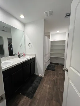 a bathroom with a double vanity sink and mirror