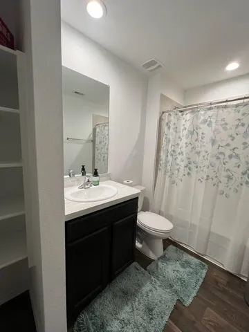 a bathroom with a sink toilet and a mirror