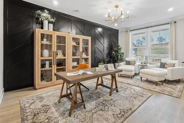 a living room with furniture window and wooden floor