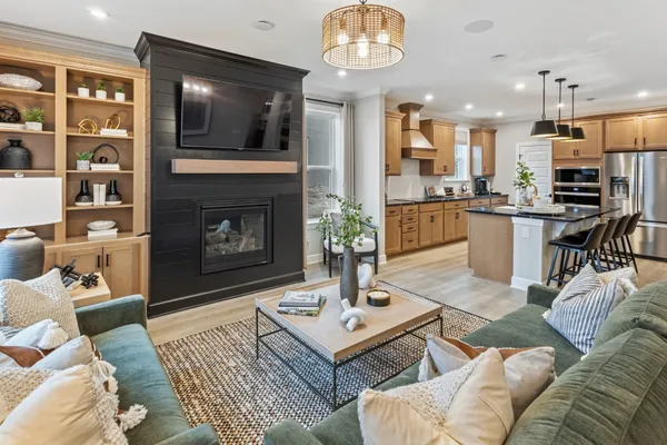 a living room with furniture a flat screen tv and a fireplace