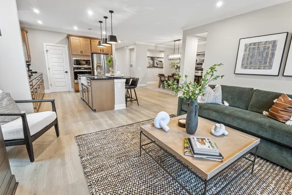 a living room with furniture and kitchen view