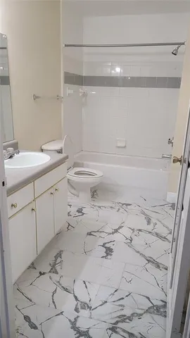 a kitchen with cabinets appliances and a refrigerator