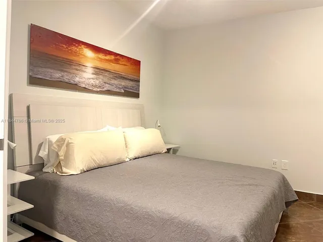 a large bed sitting in a bedroom next to a wall