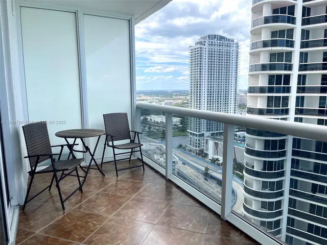 a view of a balcony with chair and table