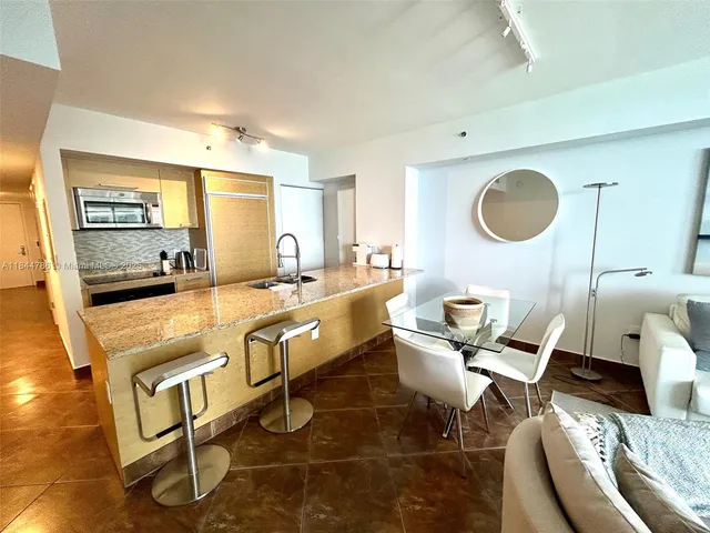 a living room with a couch and a wooden floor